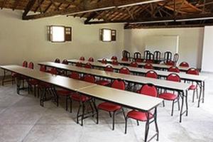 a room with tables and chairs and red chairs at Hotel Fazenda Caco de Cuia in Itabirito +53 photos