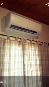 a air conditioner on the wall of a bedroom at CASA BONITA in Bonito