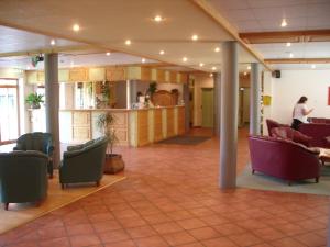 a lobby with couches and chairs in a building at Komforthotel Ahornhof in Lindberg