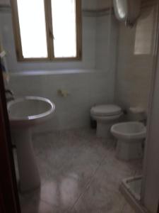 a bathroom with a sink and a toilet and a window at Casa Vacanze Silvia in Pizzo +23 photos
