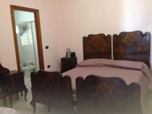 a bedroom with a large bed and a mirror at Casa Vacanze Silvia in Pizzo