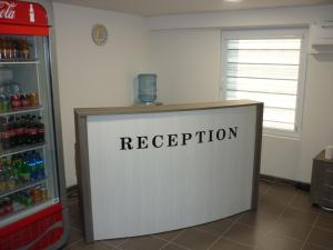 a reception desk in a room with a refrigerator at YALTA guesthouse in Ruse