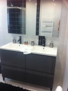 a bathroom with a white sink and a mirror at le jardin d Eau in Lamothe-Montravel