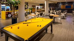 a large yellow pool table in a restaurant at ibis Joinville in Joinville