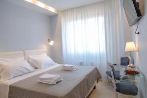 パレルモにあるB&B Attico 33のベッドルーム1室(ベッド1台、ガラステーブル、タオル付)