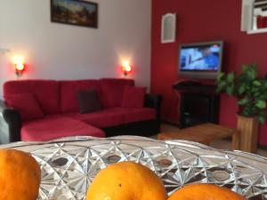 a table with oranges on it in a living room at Meublé de tourisme "Au bord de la Mare" in Salazie