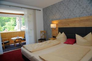 a bedroom with a large bed and a balcony at Schwarzes Lamm in Rothenburg ob der Tauber