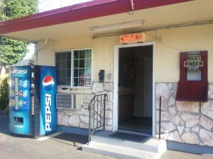 a gas station with a pepsi machine in front of it at Aaron Motel in Portland