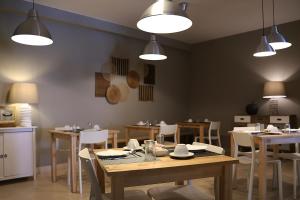 a dining room with tables and chairs and lights at Cosy Sintra in Sintra
