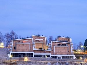 two large buildings in a field at night at Engadin's 2BDR Apartment The View in Bjelašnica