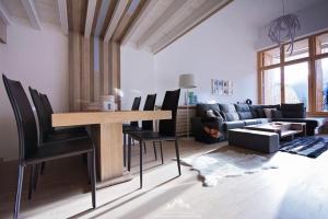 a living room with a table and chairs and a couch at Apartman View in Bjelašnica