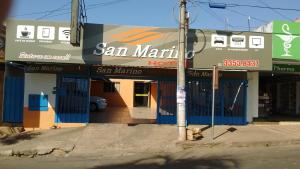 a building with a san marino hotel on a street at Hotel San Marino in Goianésia