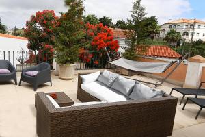 a wicker couch sitting on top of a patio at Cosy Sintra in Sintra