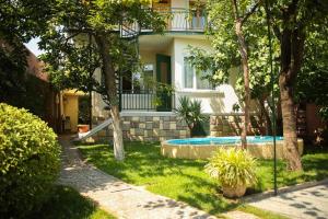 a house with a swimming pool in the yard at Natalie's Guest house in Tbilisi City