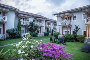 a row of houses with flowers in the yard at Nomad Suites Residence in Libreville
