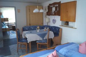 a dining room with a table and blue chairs at Pension Jagdhütte in Sankt Andreasberg
