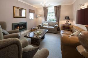 a living room with a couch and a fireplace at Raise View House in Grasmere