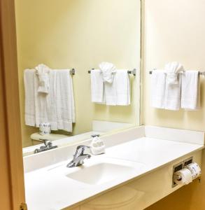 a bathroom with a white sink and a mirror at Casa Bella Hotel and Suites in South Padre Island