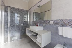 a bathroom with a sink and a shower and a mirror at Villa Cavour in Comacchio +49 photos