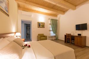 a bedroom with a bed and a desk and a television at Villa Cavour in Comacchio
