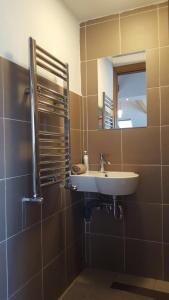 a bathroom with a sink and a mirror at Grigorescu Lux Residence in Cluj-Napoca