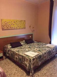 a bedroom with a bed in a room at Hotel San Donnino in Fidenza