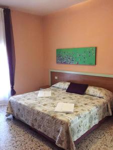 a bedroom with a bed with two laptops on it at Hotel San Donnino in Fidenza