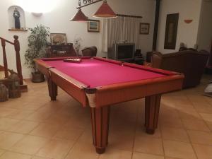 a pool table sitting in a living room with at Arrábida com Requinte in Palmela