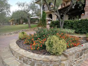 a flower garden in front of a building at La Ginestra in Castel San Lorenzo