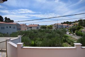 a view of a town from the balcony of a house at Guesthouse Šimag in Rab
