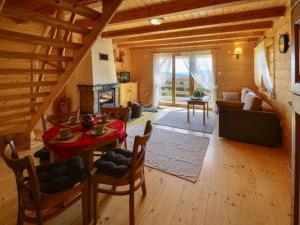 a living room with a table and chairs in a cabin at Domek drewniany simonka zawoja in Zawoja