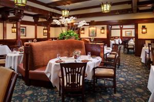 a dining room with tables and chairs in a restaurant at The Lodge at Torrey Pines in San Diego