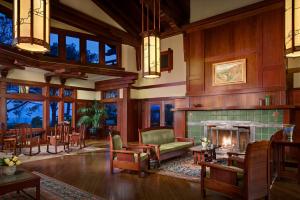 a living room with a fireplace and wooden walls at The Lodge at Torrey Pines in San Diego
