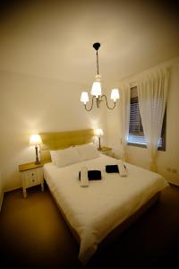 a bedroom with a large white bed with two pillows at Berger's Apartment in Eilat