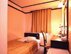 Postel nebo postele na pokoji v ubytování Niigata Terminal Hotel
