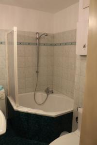 a bathroom with a bath tub with a shower at Ferienwohnung Nienhagen in Ostseebad Nienhagen +29 photos