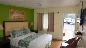 a bedroom with a bed and a sliding glass door at Eagle Crater Lake Inn in Chemult
