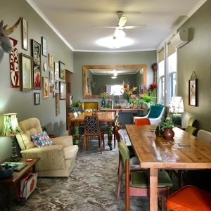 a living room with a table and a dining room at Vine Valley Inn in Cessnock
