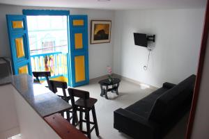 ein Wohnzimmer mit einem Sofa und einem Tisch in der Unterkunft Apartahotel Calle del tiempo detenido in Filandia