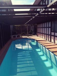 a large swimming pool in a building at Albatross Motel in Napier