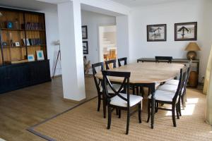 a dining room with a wooden table and chairs at Santa Cruz Ocean Villa in Gaula