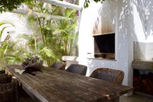a wooden table on a patio with chairs at Santa Cruz Ocean Villa in Gaula
