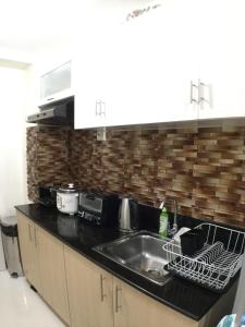 a kitchen counter with a sink and a microwave at 1237 Winds Residences in Tagaytay