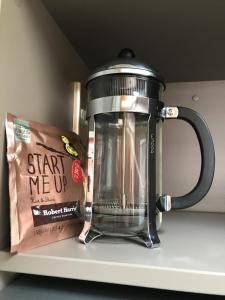 a coffee pot and a bag on a shelf at Kaiapoi on Williams Motel in Kaiapoi