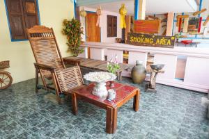 a room with a bench and chairs and a table at Zleep63 in Bangkok