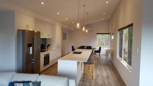 a kitchen and living room with a table and a couch at Cape Villas in Dunsborough