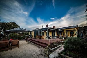 a house with a wooden deck and a patio at Barbs Place in Waipara