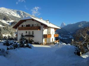 una casa en las montañas en la nieve en Nature Residence Telfnerhof, en Laion