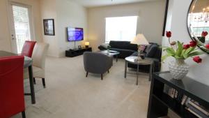 a living room with a couch and a table at Shoreway Condo #231524 in Orlando