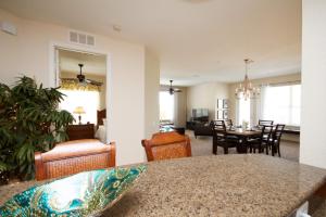 a living room and dining room with a table and chairs at Shoreway Condo #231520 in Orlando